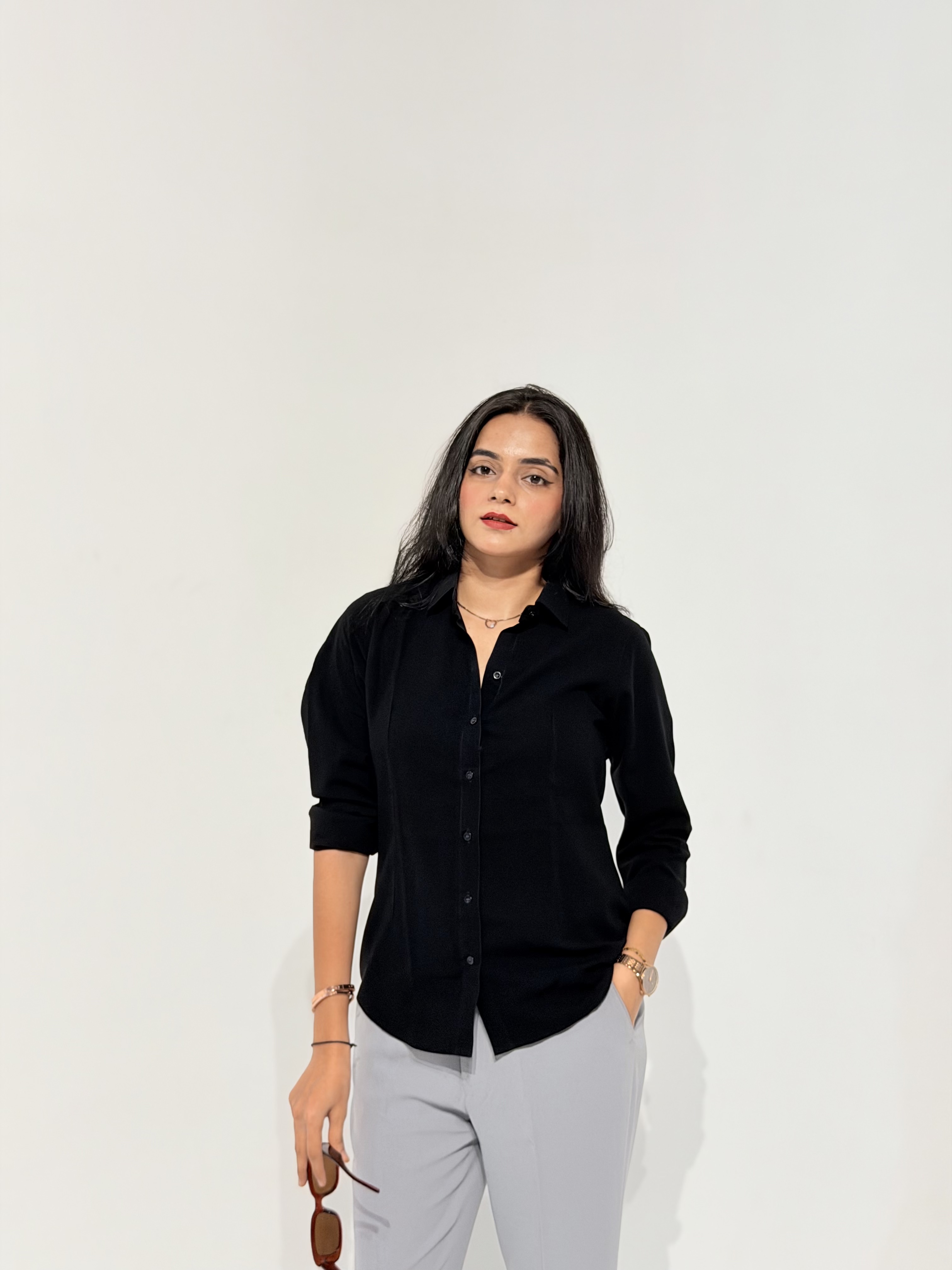 Khushboo Makhija in a black shirt and grey trousers